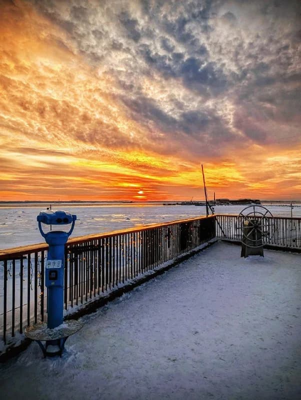 Snowy waterfront in Kronstadt at sunset