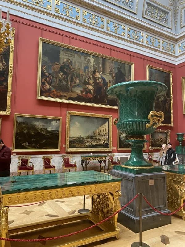 Paintings and a display case inside the Hermitage
