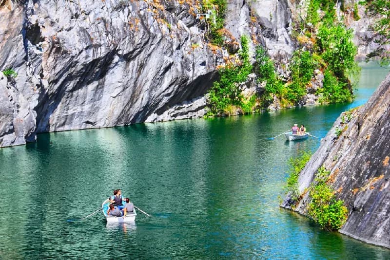 Small boat on turquoise water in Ruskeala canyon
