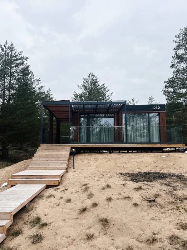 Wooden lakeside cabin among pine trees